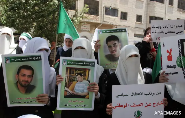 Palestinian Hamas supporters hold up pictures of relatives who were arrested and imprisoned for political reasons by Palestinian Authority security forces, during a protest in the West Bank city of Hebron, on June 09,201...