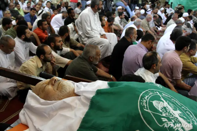 Palestinians attend Friday prayers next to the body of Mohammed Shamaa, one of the Hamas Movement founders, at Omari mosque in Gaza city on June 10,2011. Photo by Mohammed Asad