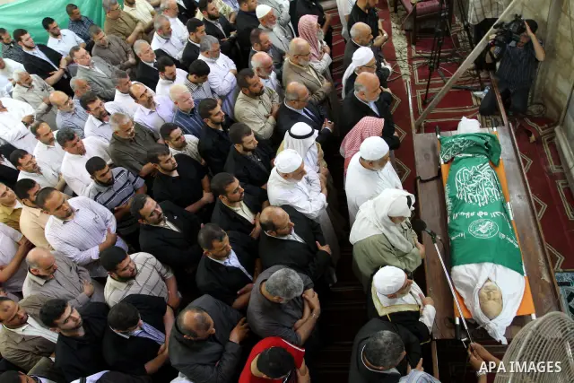 Palestinian Prime Minister in Gaza Strip, Ismail Haniya prays at the body of Mohammed Shamaa, one of the Hamas Movement founders, after Friday prayers at Omari mosque in Gaza city on June 10,2011. Photo by Mohammed Asad