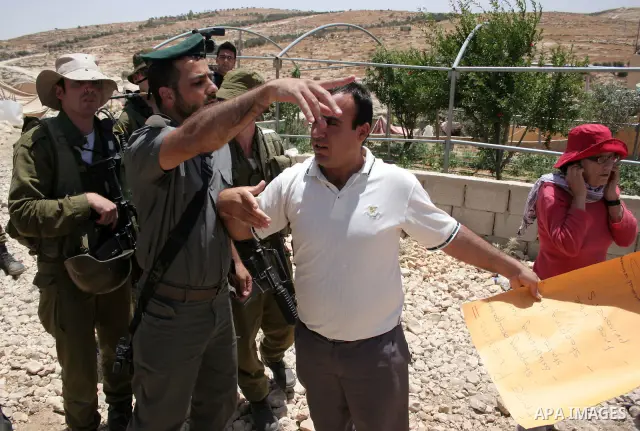 Israeli forces disperse a demonstration by Palestinian and foreign peace activists against Israeli settlements in the West Bank village of Al-Tuwani, near Hebron, on June 10,2011. Photo by Najeh Hashlamoun .