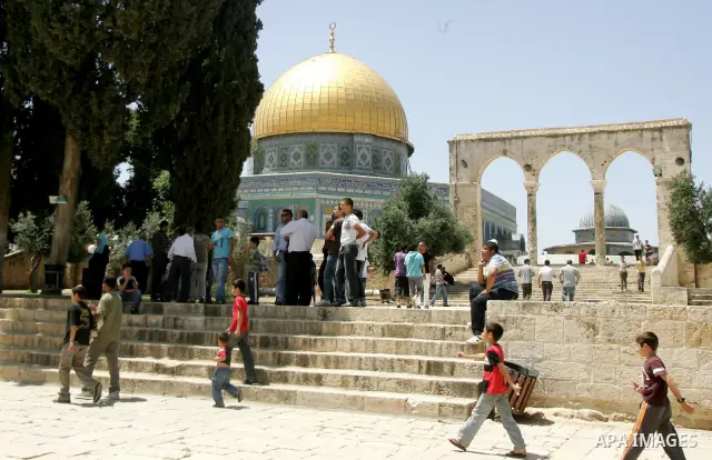 Palestinian Muslim worshipers walk in front of the Dome of the Rock after Friday prayer at the Al-Aqsa mosque compound in Jerusalem's Old City on June 10, 2011. Photo by Mahfouz Abu Turk
