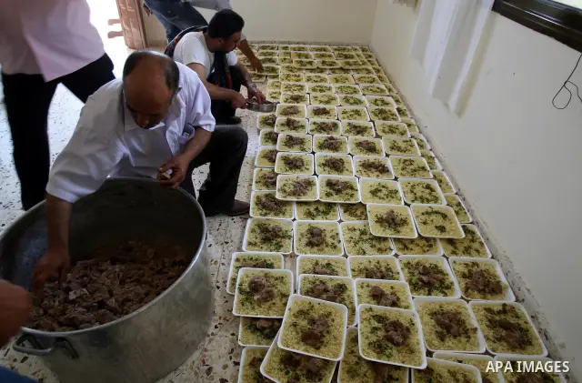 Palestinians prepare dishes of rice and meat for guests attending the wedding celebration of Alaa Sabti in the West Bank village of Salem, near Nablus , June 11, 2011. Photo by Wagdi Eshtayah