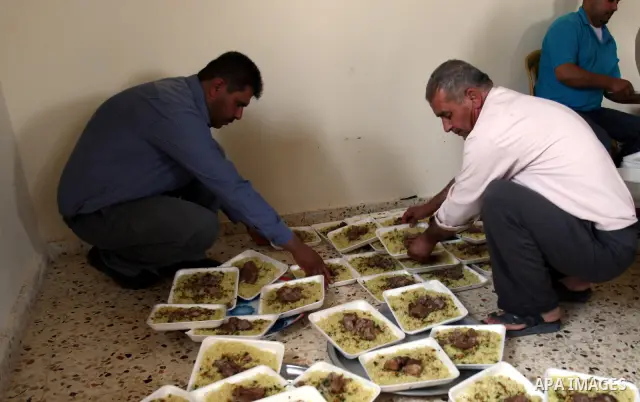 Palestinians prepare dishes of rice and meat for guests attending the wedding celebration of Alaa Sabti in the West Bank village of Salem, near Nablus , June 11, 2011. Photo by Wagdi Eshtayah