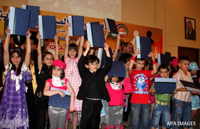 Palestinian children participate in the graduation ceremony at their kindergarten in the West Bank city of Nablus on June 12,2011. Photo by Wagdi Eshtayah