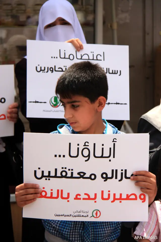 Palestinian Hamas supporters hold banners of relatives who were arrested and imprisoned for political reasons by Palestinian Authority security forces, during a protest in the West Bank city ofof Nablus on June 13, 2011....