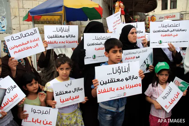 Palestinian Hamas supporters hold banners of relatives who were arrested and imprisoned for political reasons by Palestinian Authority security forces, during a protest in the West Bank city ofof Nablus on June 13, 2011....