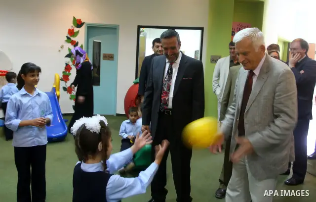 European Parliament President Jerzy Buzek (R) plays ball with a Palestinian children during his visits to Deaf Center in Gaza City on June 13, 2011. Photo/Ashraf Amra- POOL