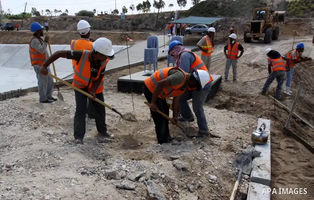 Palestinian labourers work in Gaza water treatment plant while German Development Minister, Dirk Nebel visit it, in Gaza city on June 14,2011. Photo by Mohammed Asad