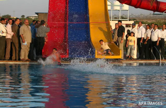 Palestinians enjoy swimming in a pool at the newly-opened "Asda City" touristic resort in Khan Yunis, south of the Gaza Strip, on June 14, 2011. Photo by Majdi Fathi