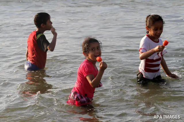 Palestinian children enjoy swimming at the beach in Gaza city on June 14, 2011. Photo by Mohammed Asad