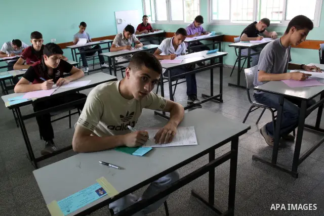 Palestinian Prime Minister in Gaza Strip, Ismail Haniya visits students as they sit for their final high school exams, known as "Tawjihi", in Gaza City on June 15, 2011. Photo by Mohammed Asad