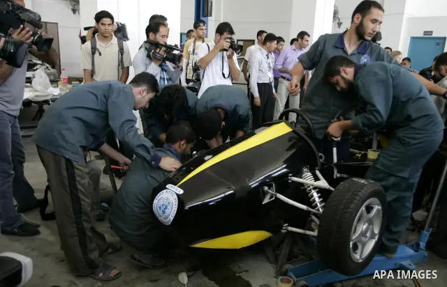 Palestinian students test their Formula 1-style racing car, made from scratch out of recycled parts, they have produced at their technical college run by the United Nations in Khan Yunis, southern Gaza Strip, on June 15,...