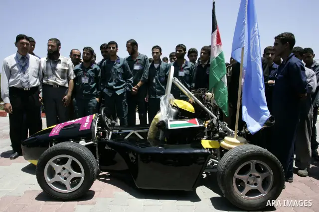 Palestinian students test their Formula 1-style racing car, made from scratch out of recycled parts, they have produced at their technical college run by the United Nations in Khan Yunis, southern Gaza Strip, on June 15,...