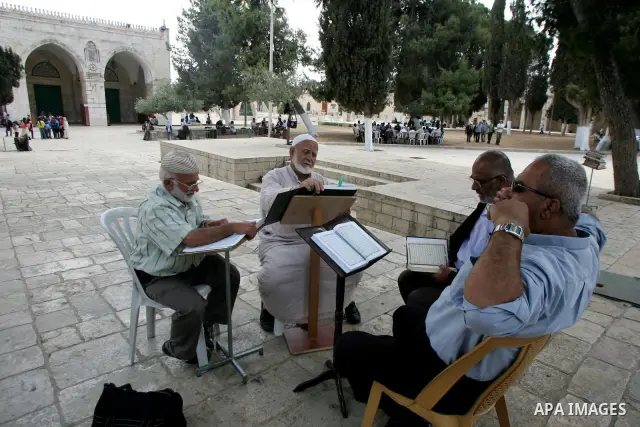 Palestinian Muslim men gather to read the Holy Quran inside the Al-Aqsa Mosque compound in Jerusalem old city on Jun 15,2011. Photo by Mahfouz Abu Turk