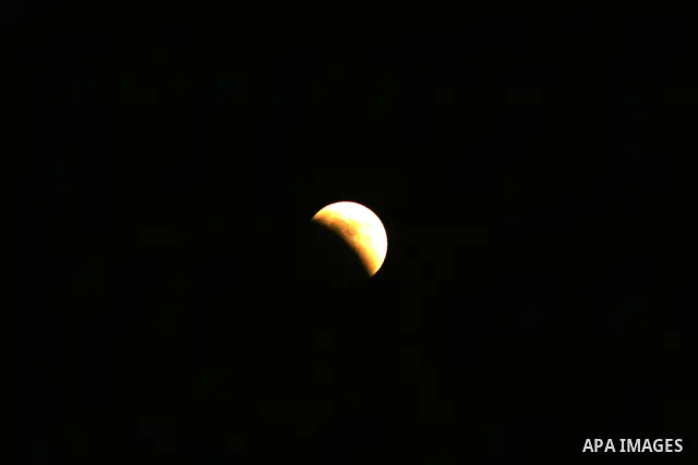 A Portion of the moon crosses into the Earth's shadow seen from Gaza city, on June 15, 2011. Astronomers in parts of Europe, Africa, Central Asia and Australia were hoping for clear skies on June 15 to enjoy a total luna...