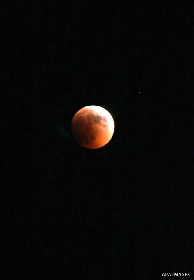 A Portion of the moon crosses into the Earth's shadow seen from the west Bank city of Nablus, on June 15, 2011. Astronomers in parts of Europe, Africa, Central Asia and Australia were hoping for clear skies on June 15 to...