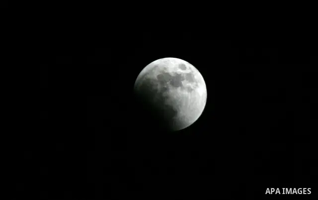 A Portion of the moon crosses into the Earth's shadow seen from Gaza Strip, Rafah City, on June 15, 2011. Astronomers in parts of Europe, Africa, Central Asia and Australia were hoping for clear skies on June 15 to enjoy...