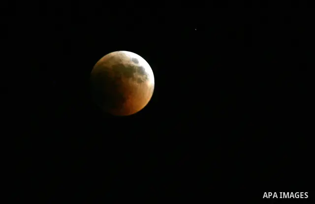 A Portion of the moon crosses into the Earth's shadow seen from Gaza Strip, Rafah City, on June 15, 2011. Astronomers in parts of Europe, Africa, Central Asia and Australia were hoping for clear skies on June 15 to enjoy...