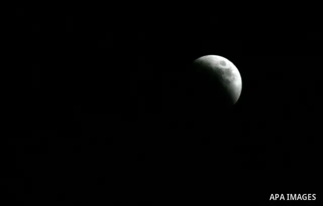 A Portion of the moon crosses into the Earth's shadow seen from Gaza Strip, Rafah City, on June 15, 2011. Astronomers in parts of Europe, Africa, Central Asia and Australia were hoping for clear skies on June 15 to enjoy...