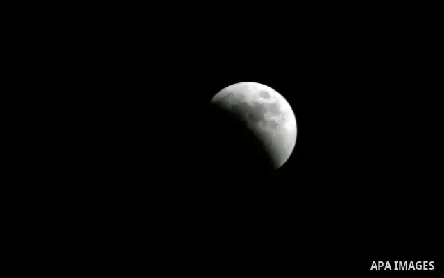 A Portion of the moon crosses into the Earth's shadow seen from Gaza Strip, Rafah City, on June 15, 2011. Astronomers in parts of Europe, Africa, Central Asia and Australia were hoping for clear skies on June 15 to enjoy...