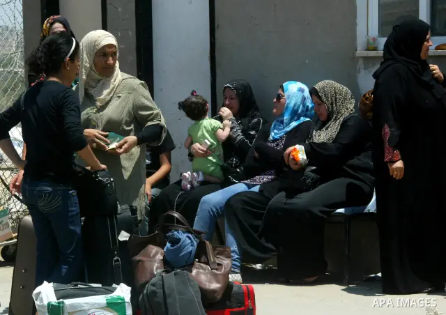 Palestinians wait at the gates of the Rafah border crossing during a rally in the southern Gaza Strip on June 16, 2011, demanding it to be open permanently and without restrictions or conditions on the passengers. Photo...