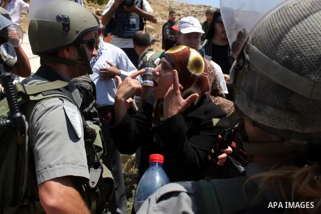 Israeli border guards hold back Palestinian protestors as residents from the village of Deir Qadis near Ramallah hold a demonstration against the expansion of nearby settlements on June 16, 2011, in the Israeli-occupied...