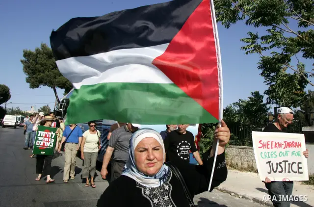 Palestinian demonstrators wave their national flag in the mostly Arab Jerusalem neighbourhood of Sheikh Jarrah on Jun 17, 2011 during a weekly demonstration by Israeli, Palestinian and international activists. Photo by M...
