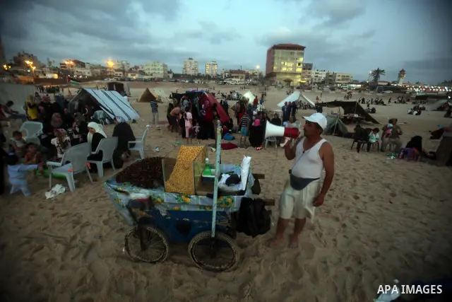A Palestinian vendor on a beach in the west of Gaza City 17 June 2011. Reports state that during the summer the beach is a major venue for entertainment and leisure in the Gaza Strip. Photo by Ali Jadallah