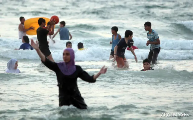 Palestinians bathing in the sea off on a beach in the west of Gaza City 17 June 2011. Reports state that during the summer the beach is a major venue for entertainment and leisure in the Gaza Strip.. Photo by Ali Jadalla...