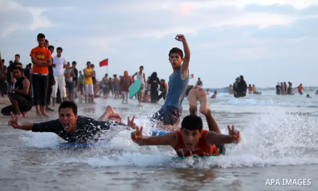 Palestinians bathing in the sea off on a beach in the west of Gaza City 17 June 2011. Reports state that during the summer the beach is a major venue for entertainment and leisure in the Gaza Strip.. Photo by Ali Jadalla...