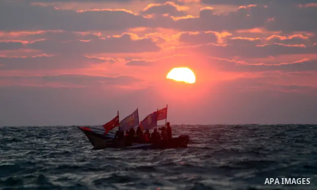 A Palestinian fishing boat as the sun goes down off a beach in the west of Gaza City 17 June 2011. Reports state that during the summer the beach is a major venue for entertainment and leisure in the Gaza Strip. Photo by...