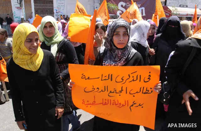 Members of Palestinian National Initiative movement participate in a rally to mark the ninth anniversary of the movement foundation in Gaza city on Jun 18,2011. Photo by Mohammed Asad