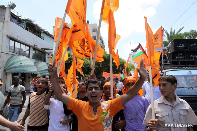 Members of Palestinian National Initiative movement participate in a rally to mark the ninth anniversary of the movement foundation in Gaza city on Jun 18,2011. Photo by Mohammed Asad