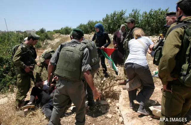 Israeli soldiers scuffle with protesters on Jun 18, 2011 during a demonstration by foreign, Israeli and Palestinian activists against the Jewish settlement of Karmei Tzur near the Palestinian village of Beit Omar, just n...