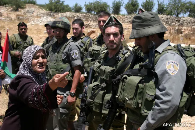 Israeli soldiers scuffle with protesters on Jun 18, 2011 during a demonstration by foreign, Israeli and Palestinian activists against the Jewish settlement of Karmei Tzur near the Palestinian village of Beit Omar, just n...