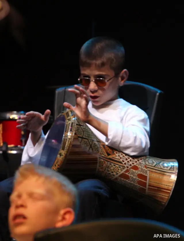Blind Palestinian children sing and play on the musical instruments during a ceremony in the West Bank city of Ramallah on Jun 18,2011. Photo by Issam Rimawi
