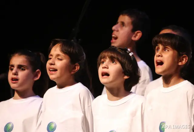 Blind Palestinian children sing and play on the musical instruments during a ceremony in the West Bank city of Ramallah on Jun 18,2011. Photo by Issam Rimawi