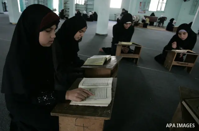 Palestinian girls read the Koran at a summer camp for the study of Islam's holy book organised by the Islamist movement Hamas in Rafah in the southern of Gaza Strip on June 19, 2011. Photo by Abed Rahim Khatib