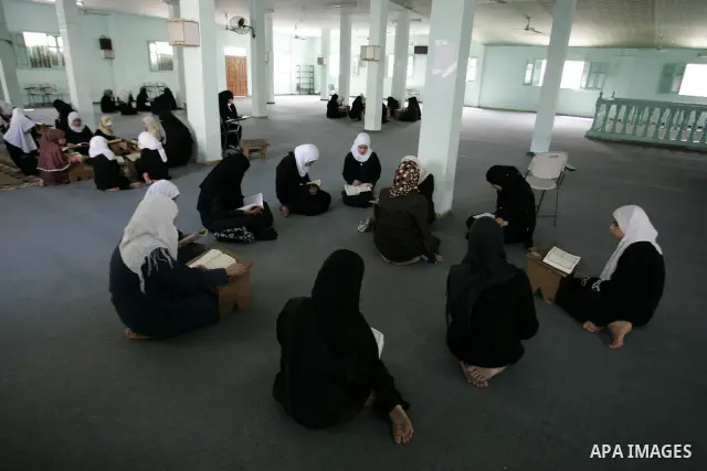 Palestinian girls read the Koran at a summer camp for the study of Islam's holy book organised by the Islamist movement Hamas in Rafah in the southern of Gaza Strip on June 19, 2011. Photo by Abed Rahim Khatib