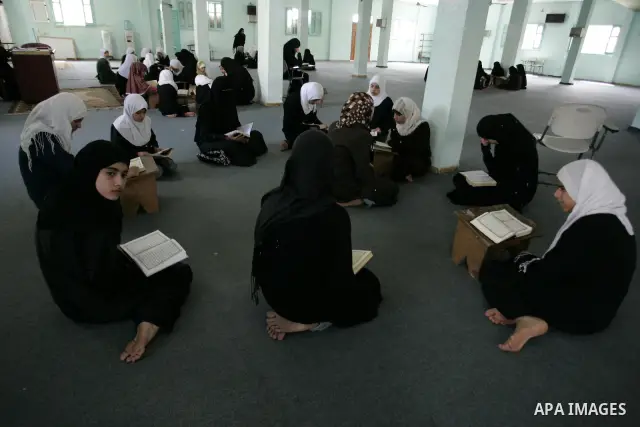 Palestinian girls read the Koran at a summer camp for the study of Islam's holy book organised by the Islamist movement Hamas in Rafah in the southern of Gaza Strip on June 19, 2011. Photo by Abed Rahim Khatib