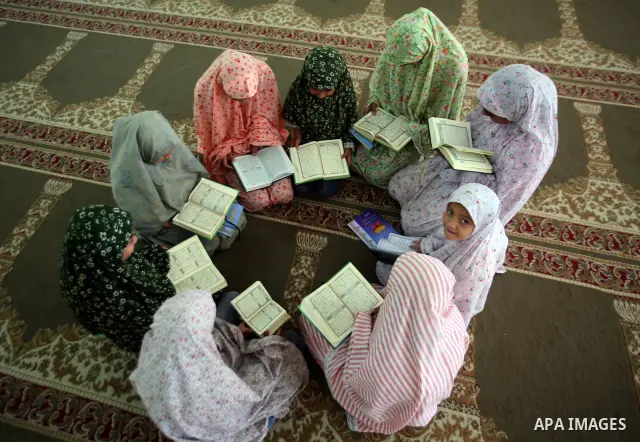 Palestinian girls read the Koran at a summer camp organised by the Islamist movement Hamas in Gaza City, 19 June 2011. About 20,000 students, both male and female, study under the instruction of 1,200 teachers. Hamas usu...