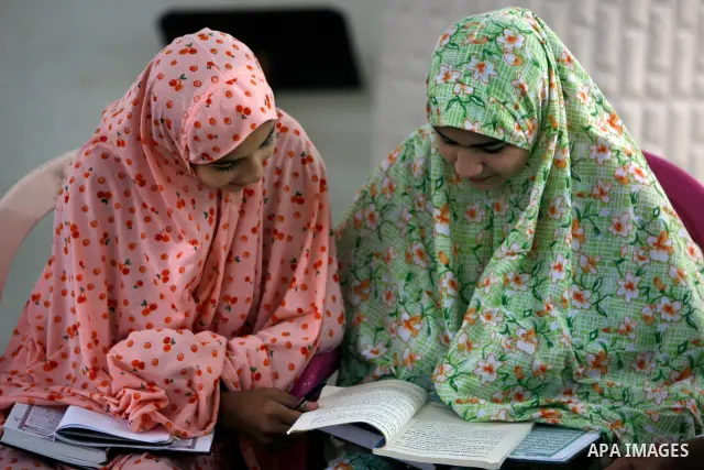 Palestinian girls read the Koran at a summer camp organised by the Islamist movement Hamas in Gaza City, 19 June 2011. About 20,000 students, both male and female, study under the instruction of 1,200 teachers. Hamas usu...