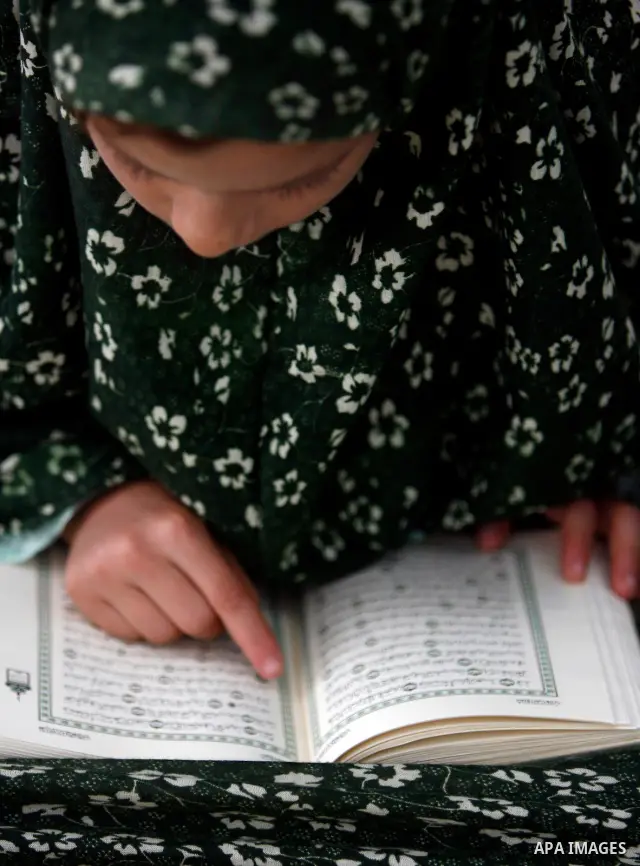 Palestinian girls read the Koran at a summer camp organised by the Islamist movement Hamas in Gaza City, 19 June 2011. About 20,000 students, both male and female, study under the instruction of 1,200 teachers. Hamas usu...