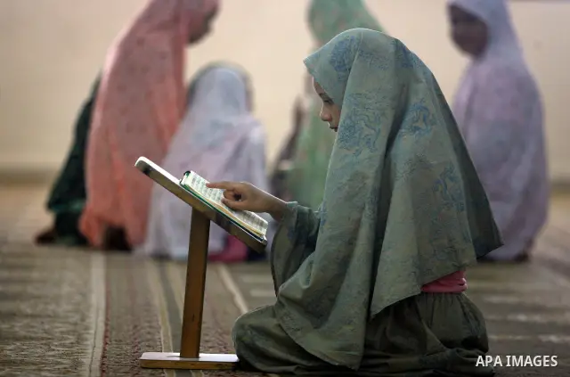 Palestinian girls read the Koran at a summer camp organised by the Islamist movement Hamas in Gaza City, 19 June 2011. About 20,000 students, both male and female, study under the instruction of 1,200 teachers. Hamas usu...
