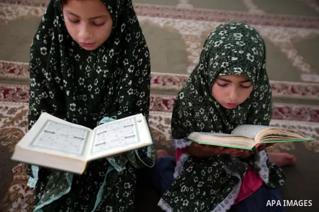 Palestinian girls read the Koran at a summer camp organised by the Islamist movement Hamas in Gaza City, 19 June 2011. About 20,000 students, both male and female, study under the instruction of 1,200 teachers. Hamas usu...