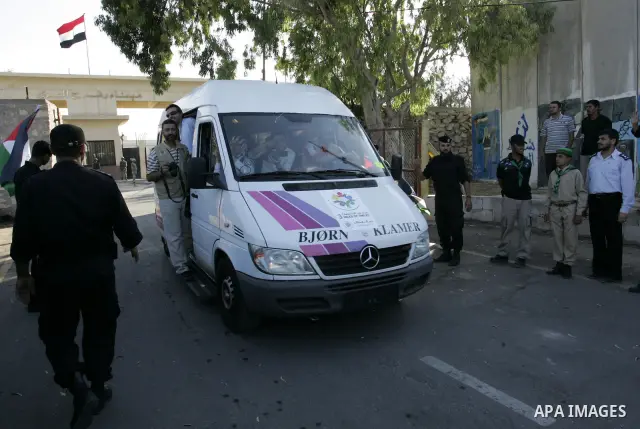 A convoy of "Miles of Smiles 3" carrying medical aid to Gaza crosses the Rafah crossing into the southern Gaza Strip from Egypt on June 19, 2011. The convoy, carrying medical aid for the impoverished Palestinian territor...