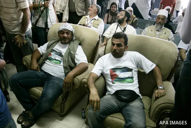 Activists from the "Miles of Smiles 3" charity are welcomed by locals after crossing with medical aid into Gaza through the Rafah crossing Egypt on June 19, 2011. The convoy, carrying medical aid for the impoverished Pal...