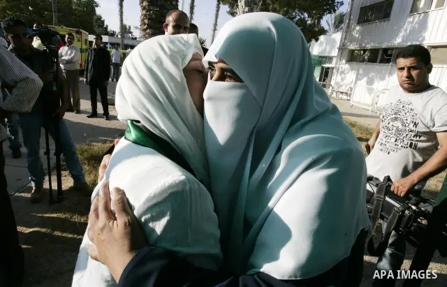Activists from the "Miles of Smiles 3" charity are welcomed by locals after crossing with medical aid into Gaza through the Rafah crossing Egypt on June 19, 2011. The convoy, carrying medical aid for the impoverished Pal...