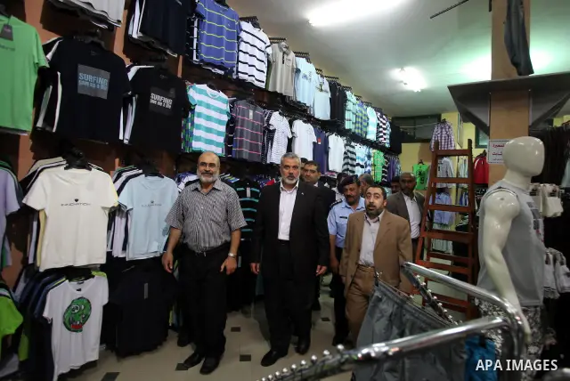 Palestinian Prime Minister in Gaza, Ismail Haniya inspect clothing stores during the opening ceremony of Al-Shuhada Street in Gaza City on June 19, 2011. Photo by Ali Jadallah
