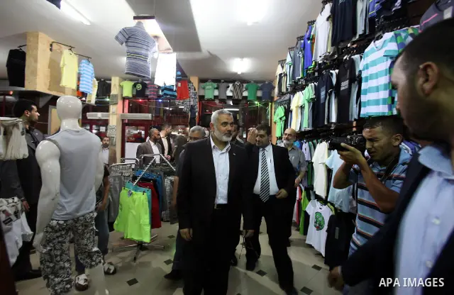 Palestinian Prime Minister in Gaza, Ismail Haniya inspect clothing stores during the opening ceremony of Al-Shuhada Street in Gaza City on June 19, 2011. Photo by Ali Jadallah